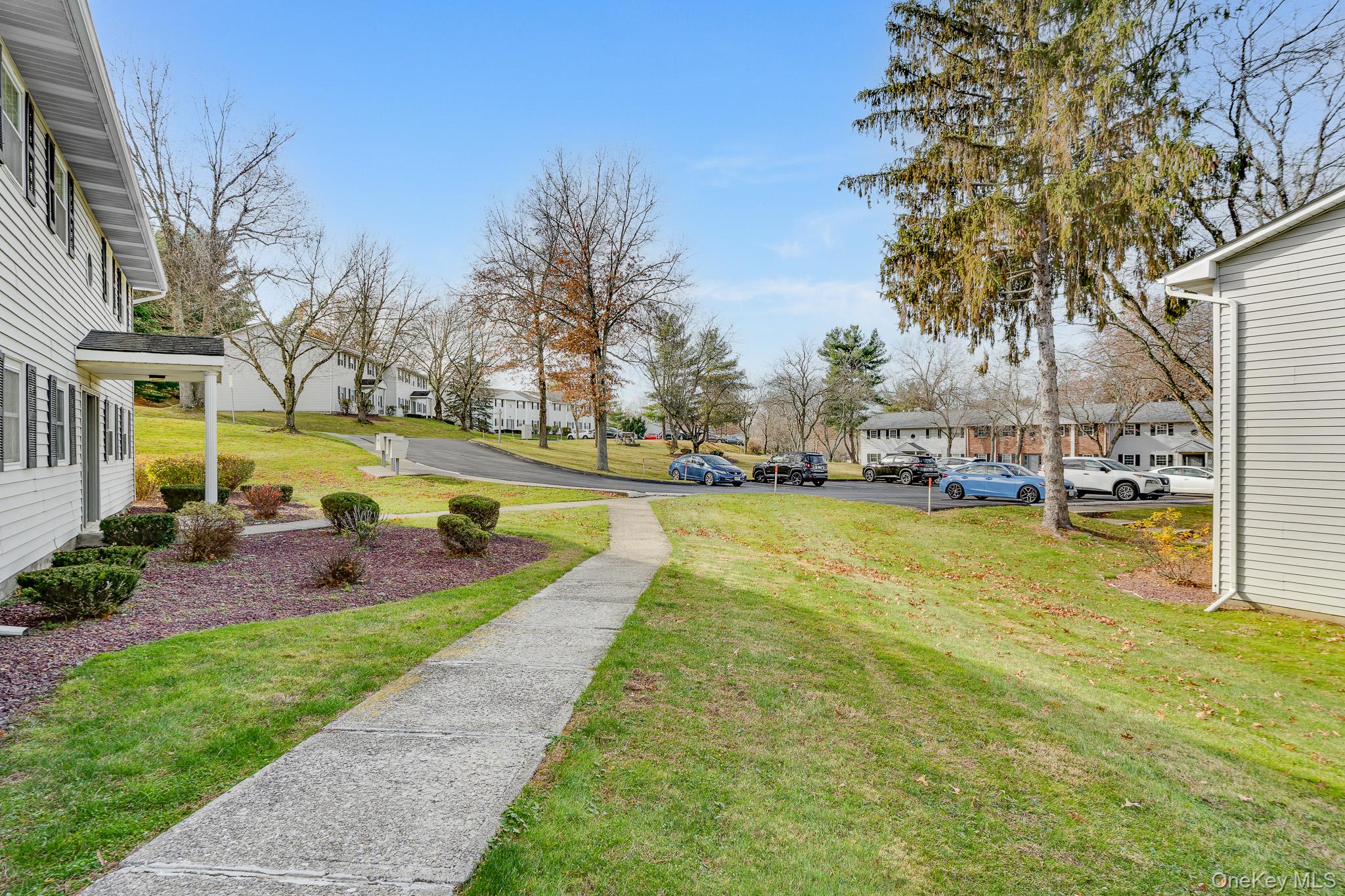 1 Locust Court, Unit C Fishkill, NY 12524 - Photo 19 of 21 a view of swimming pool with outdoor seating and trees in the background
