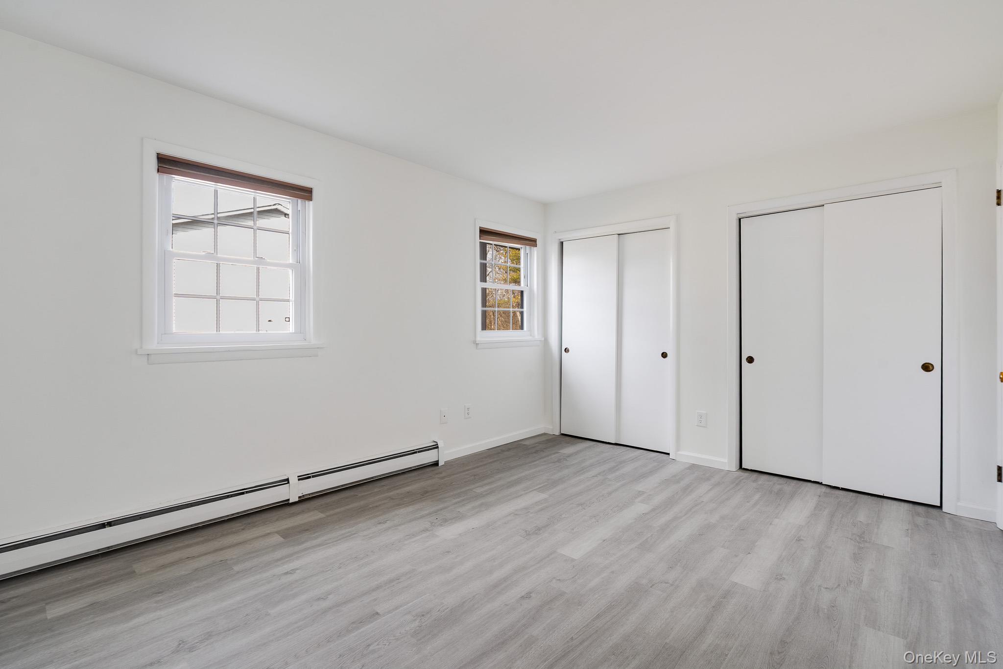 1 Locust Court, Unit C Fishkill, NY 12524 - Photo 6 of 21 an empty room with wooden floor and windows