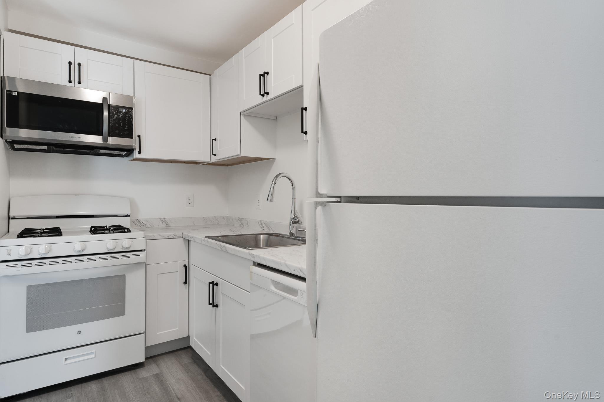 1 Locust Court, Unit C Fishkill, NY 12524 - Photo 7 of 21 a kitchen with stainless steel appliances white cabinets and a stove top oven