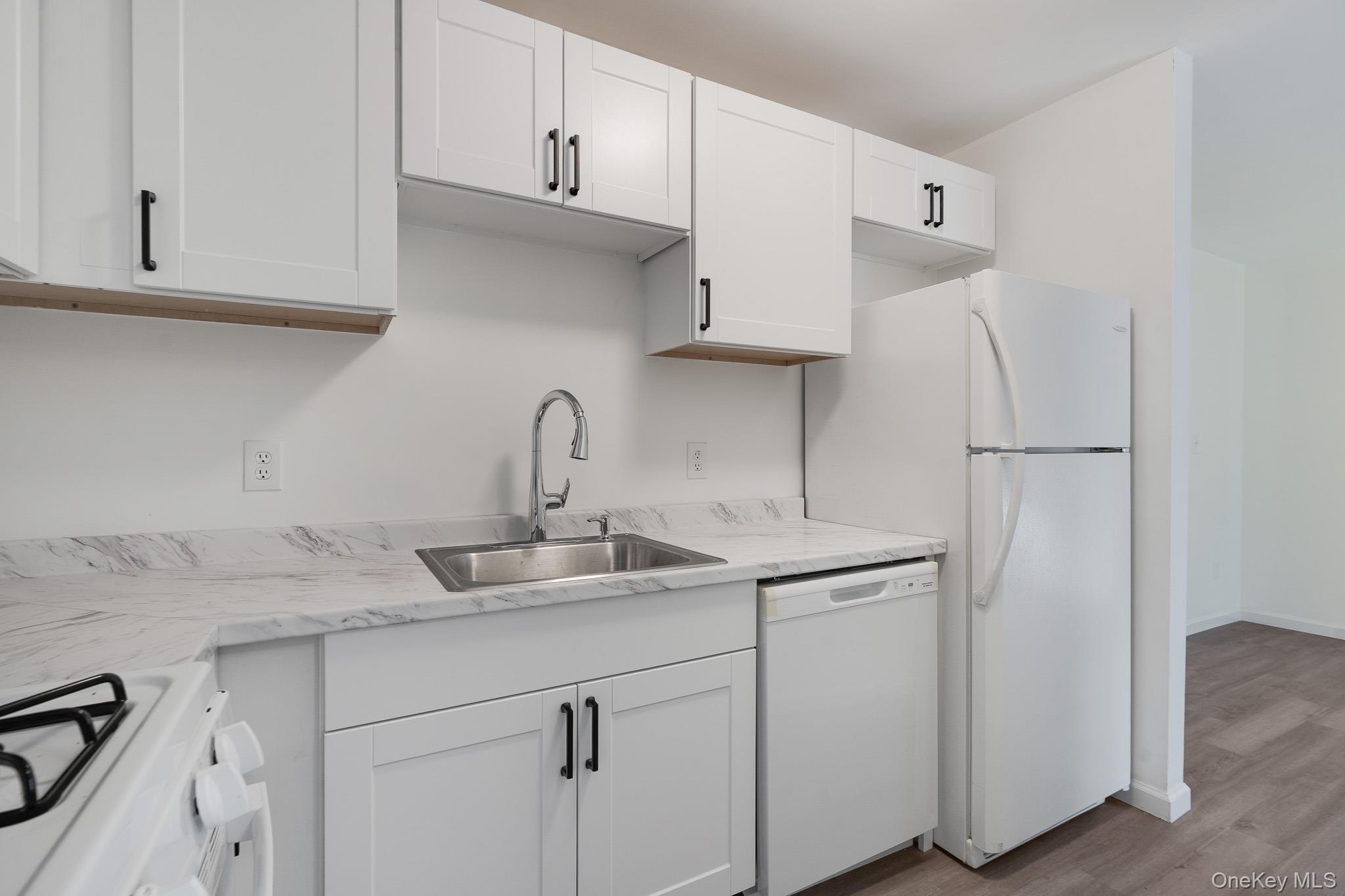 1 Locust Court, Unit C Fishkill, NY 12524 - Photo 8 of 21 a kitchen with stainless steel appliances granite countertop white refrigerator sink and cabinets