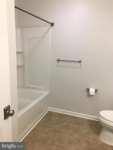 a bathroom with a shower and a toilet