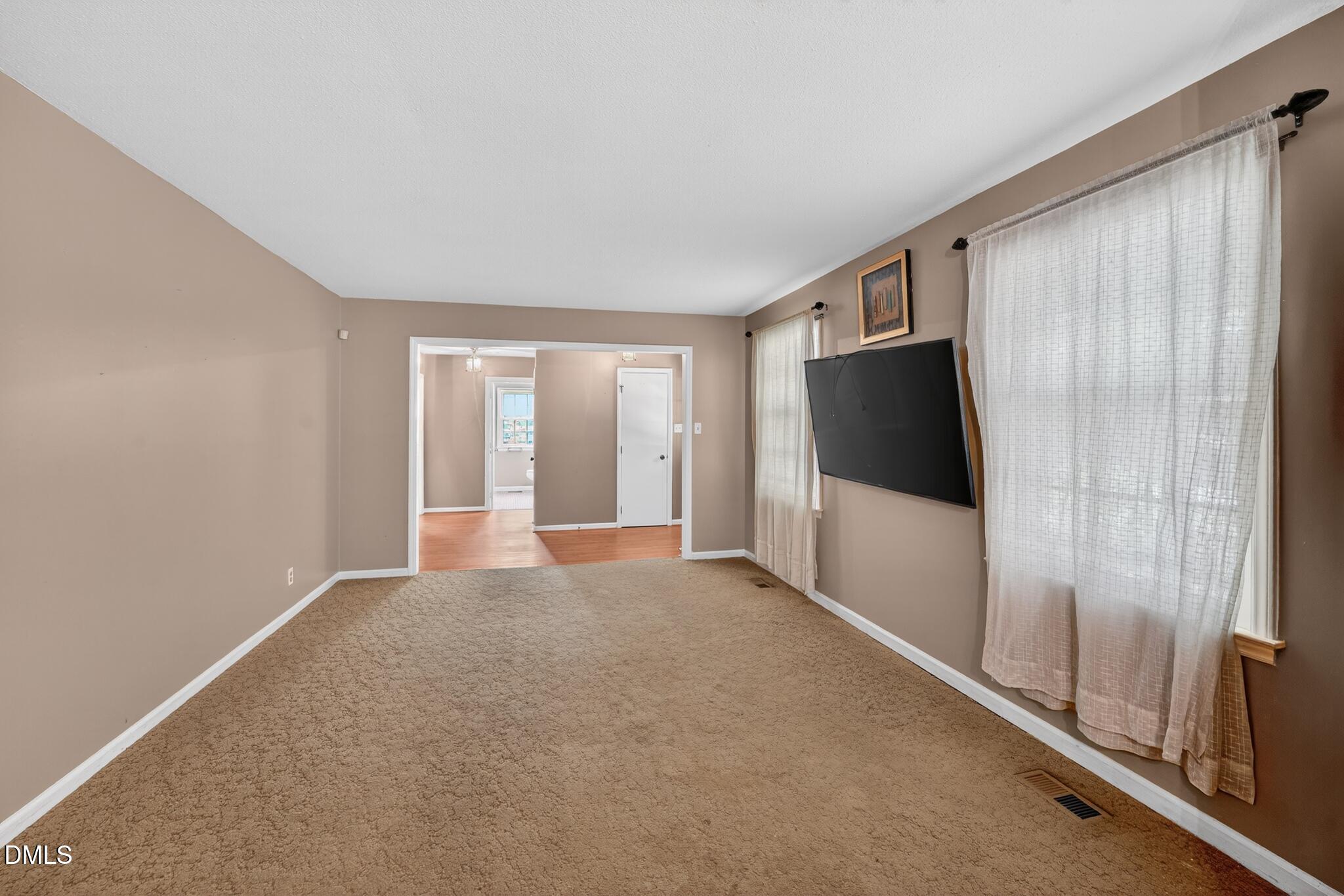 1034 Jerome Road Durham, NC 27713 - Photo 5 of 35 a view of a livingroom with an empty space and a window