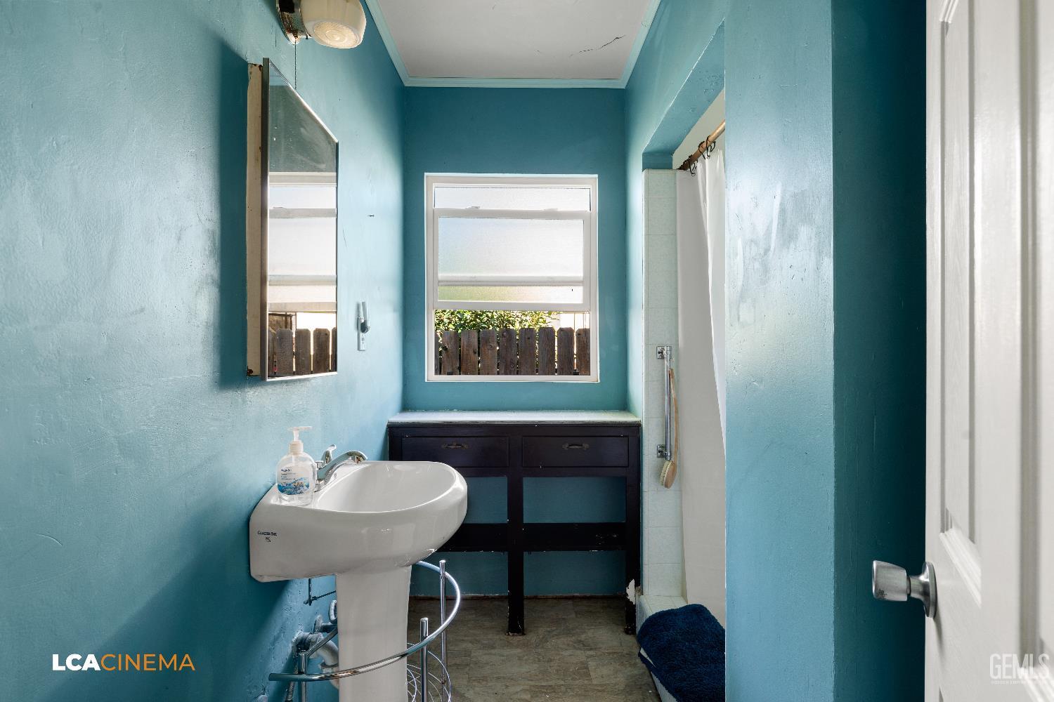 Undisclosed Address Bakersfield, CA 93308 - Photo 11 of 19 a bathroom with a sink and a mirror