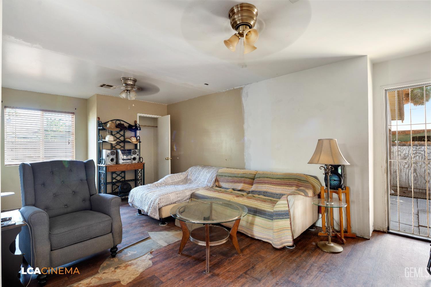 Undisclosed Address Bakersfield, CA 93308 - Photo 15 of 19 a bedroom with furniture and a wooden floor