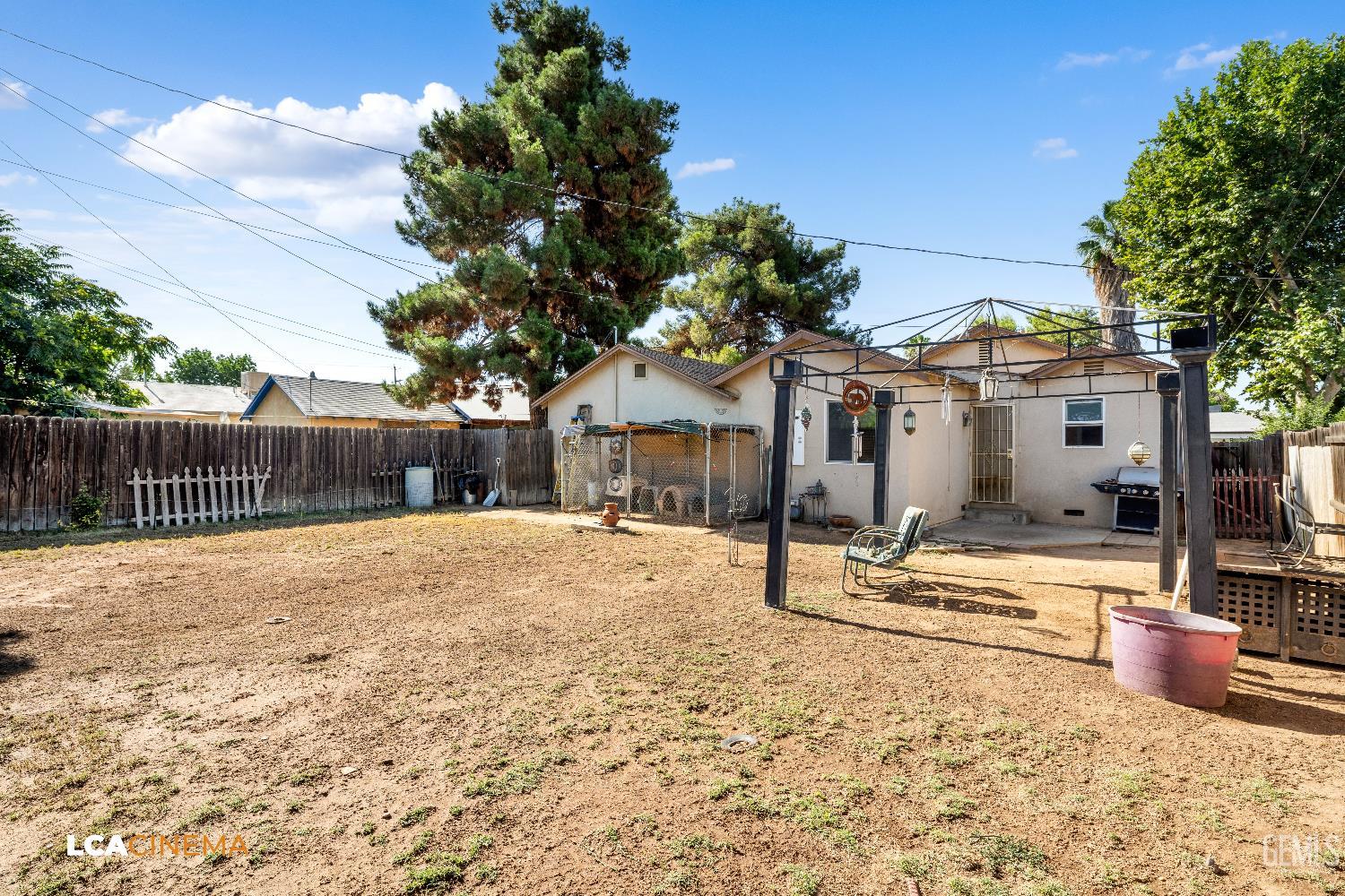 Undisclosed Address Bakersfield, CA 93308 - Photo 18 of 19 a front view of a house with wooden fence next to a yard