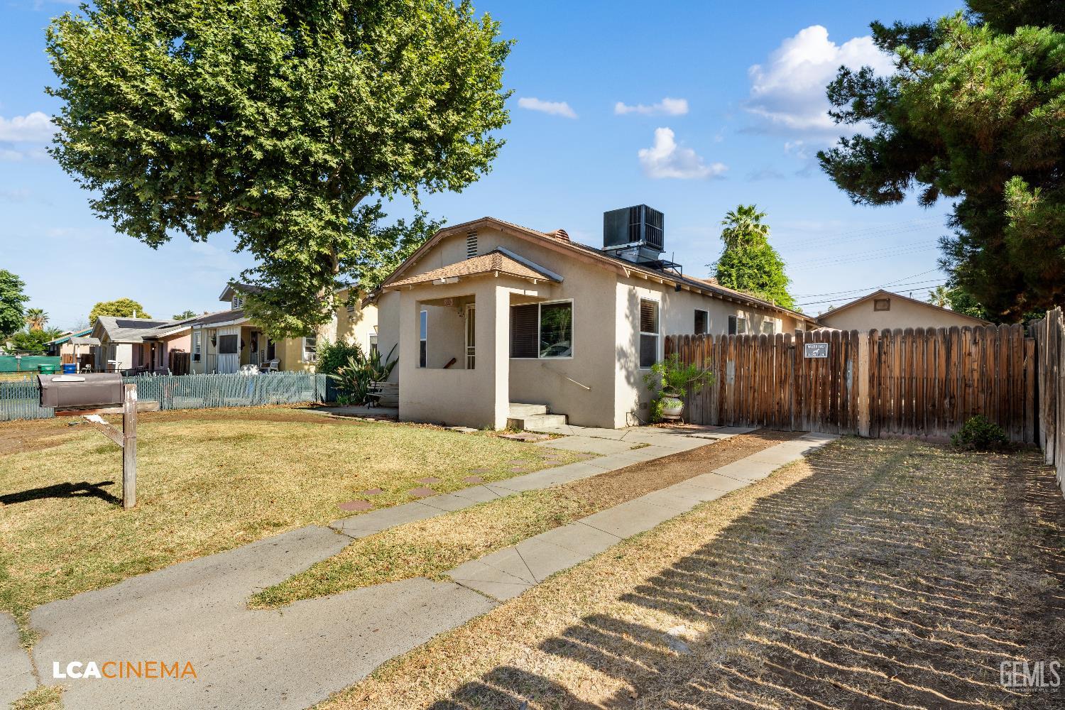Undisclosed Address Bakersfield, CA 93308 - Photo 2 of 19 a front view of a house with a yard and garage
