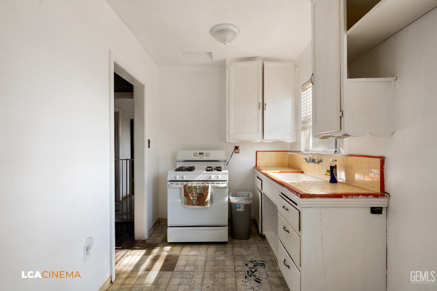 Undisclosed Address Bakersfield, CA 93308 - Photo 5 of 19 a kitchen with a sink stove and cabinets