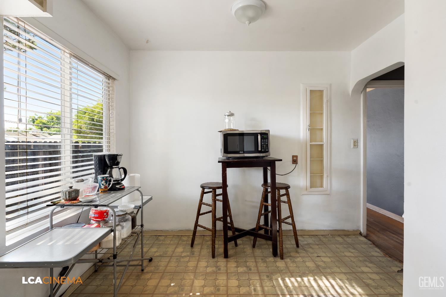 Undisclosed Address Bakersfield, CA 93308 - Photo 6 of 19 a view of a workspace with furniture and a window