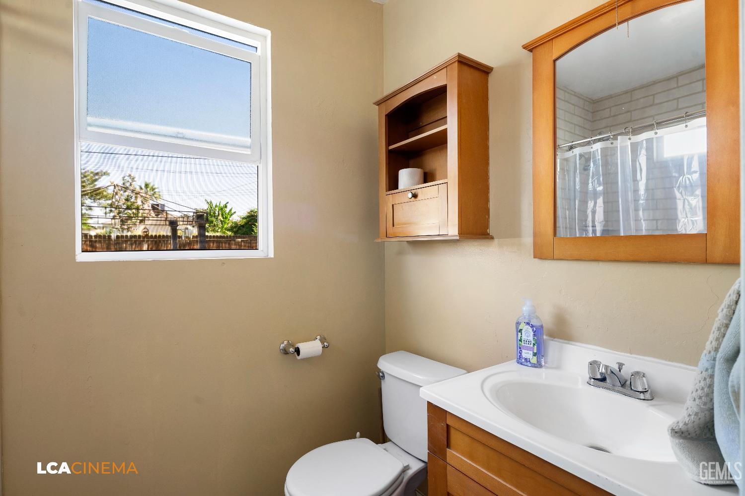 Undisclosed Address Bakersfield, CA 93308 - Photo 9 of 19 a bathroom with a sink mirror and toilet