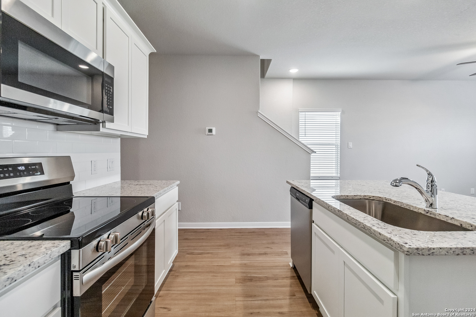 3928 Abbott Pass St. Hedwig, TX 78152 - Photo 11 of 35 a kitchen with stainless steel appliances granite countertop a sink and a microwave