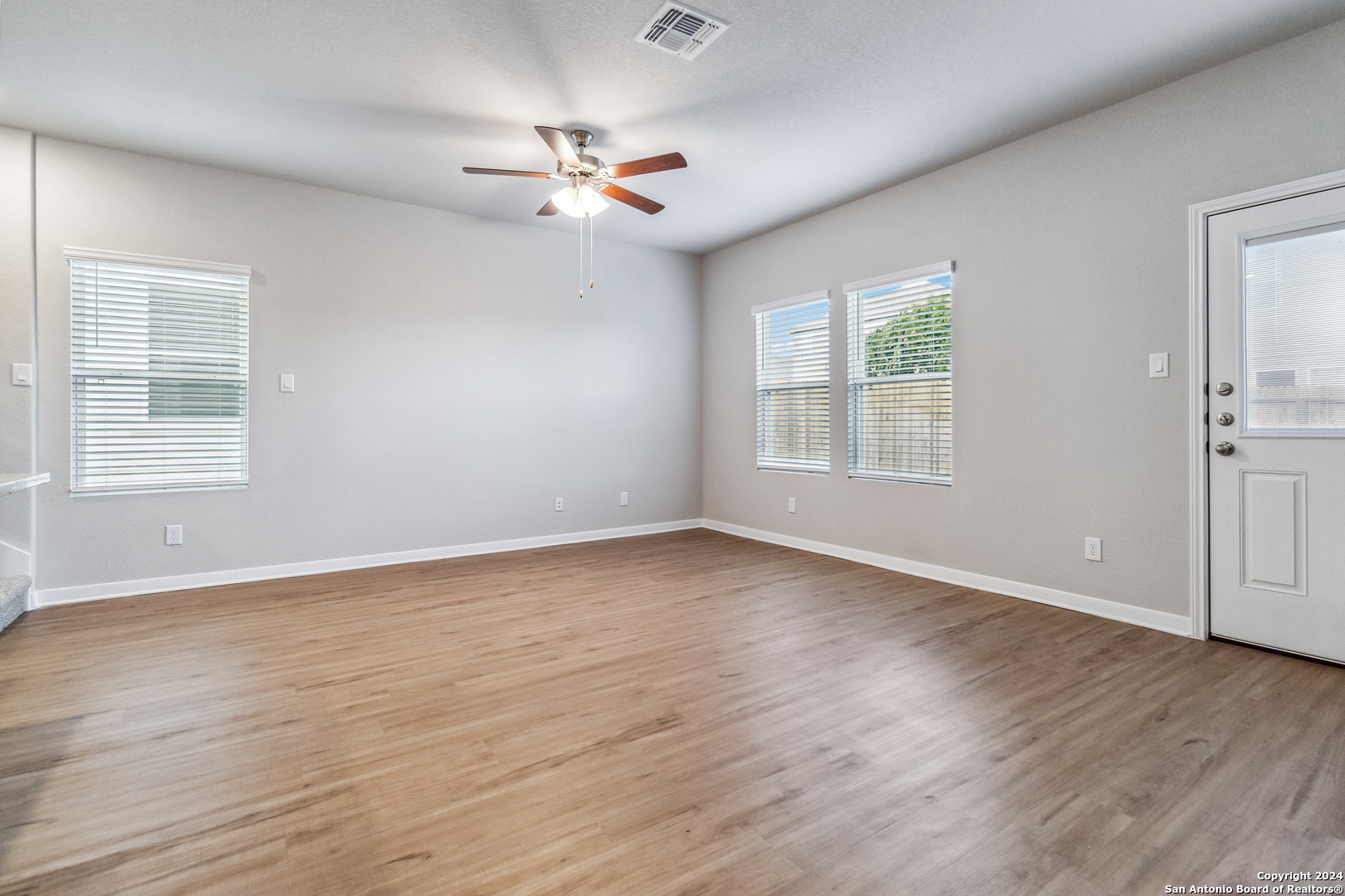 3928 Abbott Pass St. Hedwig, TX 78152 - Photo 12 of 35 a view of an empty room with wooden floor and a window