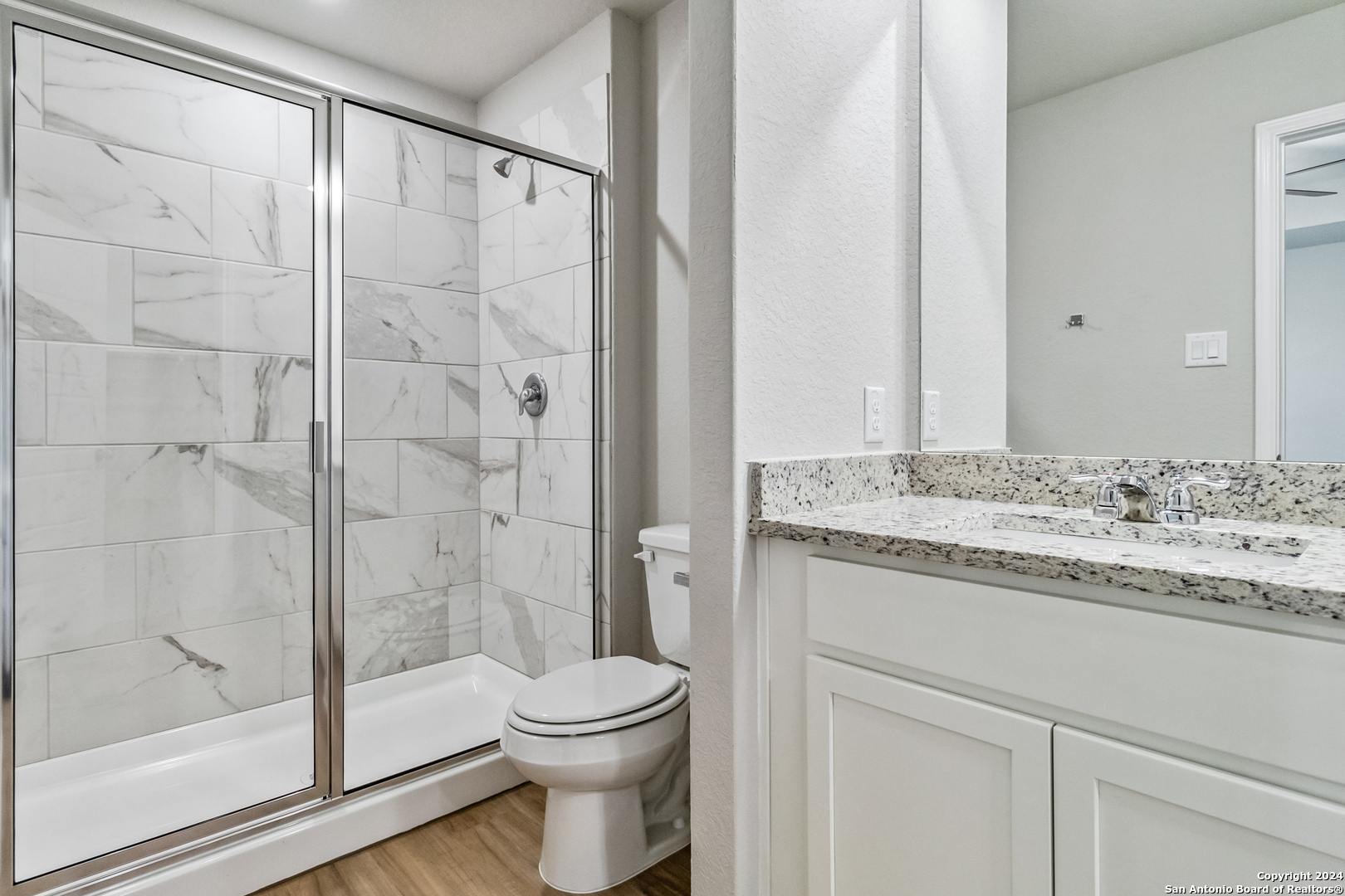 3928 Abbott Pass St. Hedwig, TX 78152 - Photo 28 of 35 a bathroom with a granite countertop sink toilet and shower