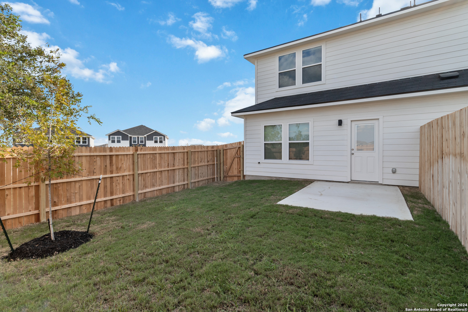 3928 Abbott Pass St. Hedwig, TX 78152 - Photo 33 of 35 a view of a backyard with a large tree