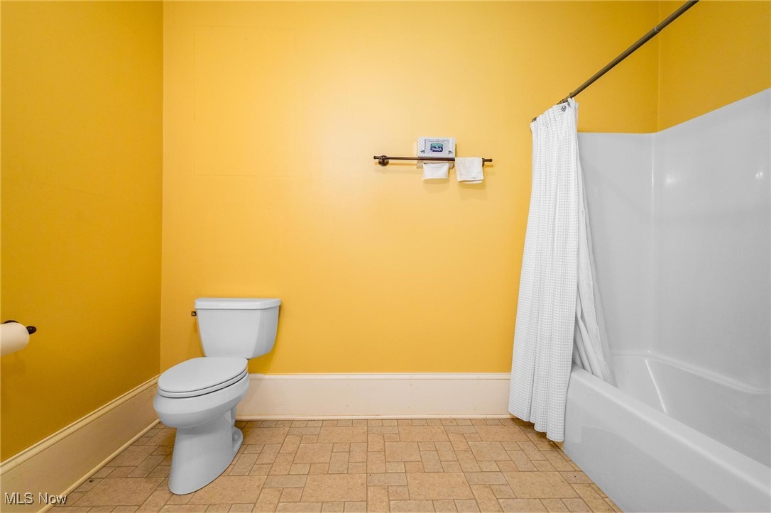 35955-35959 Bower Road Scio, OH 43988 - Photo 29 of 50 Bathroom with toilet, tile flooring, and shower / tub combo with curtain