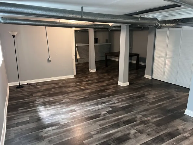 a view of a room with wooden floor