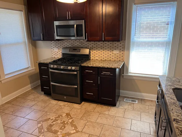 a kitchen with a stove and a microwave