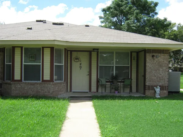a view of a brick house with a large windows