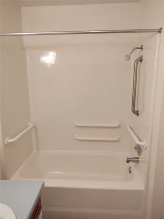 a bathroom with a shower and a bath tub