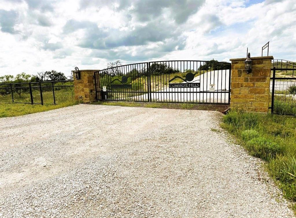 109 Comanche Hills Comanche, TX 76442 - Photo 3 of 25 a view of a pathway with a wrought fence