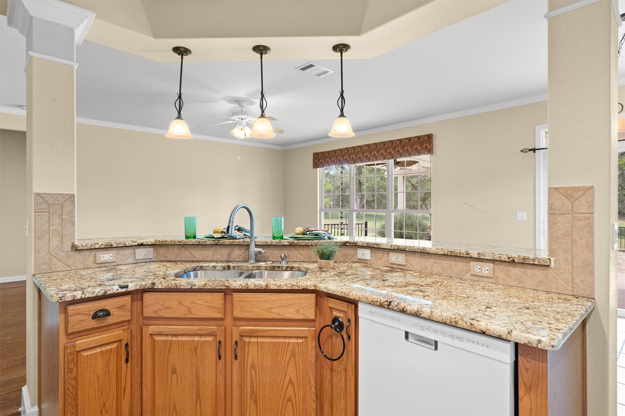 321 Yukon Terrace Georgetown, TX 78633 - Photo 4 of 15 a kitchen with granite countertop a sink and a wooden floor