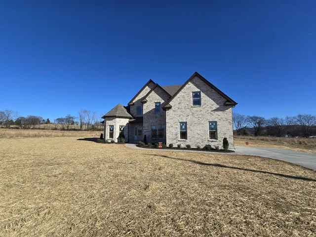 a view of a house with a yard and ocean view