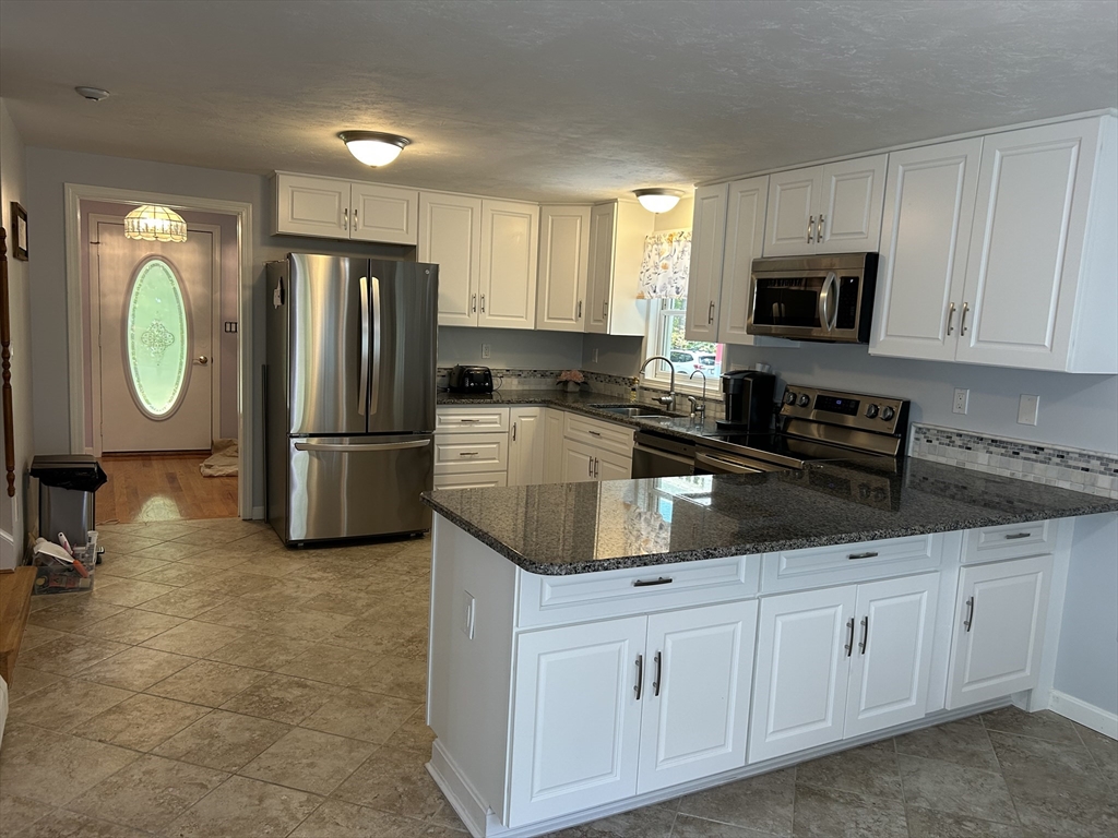 31 Bay Path Road Charlton, MA 01507 - Photo 12 of 42 a kitchen with a refrigerator sink and cabinets