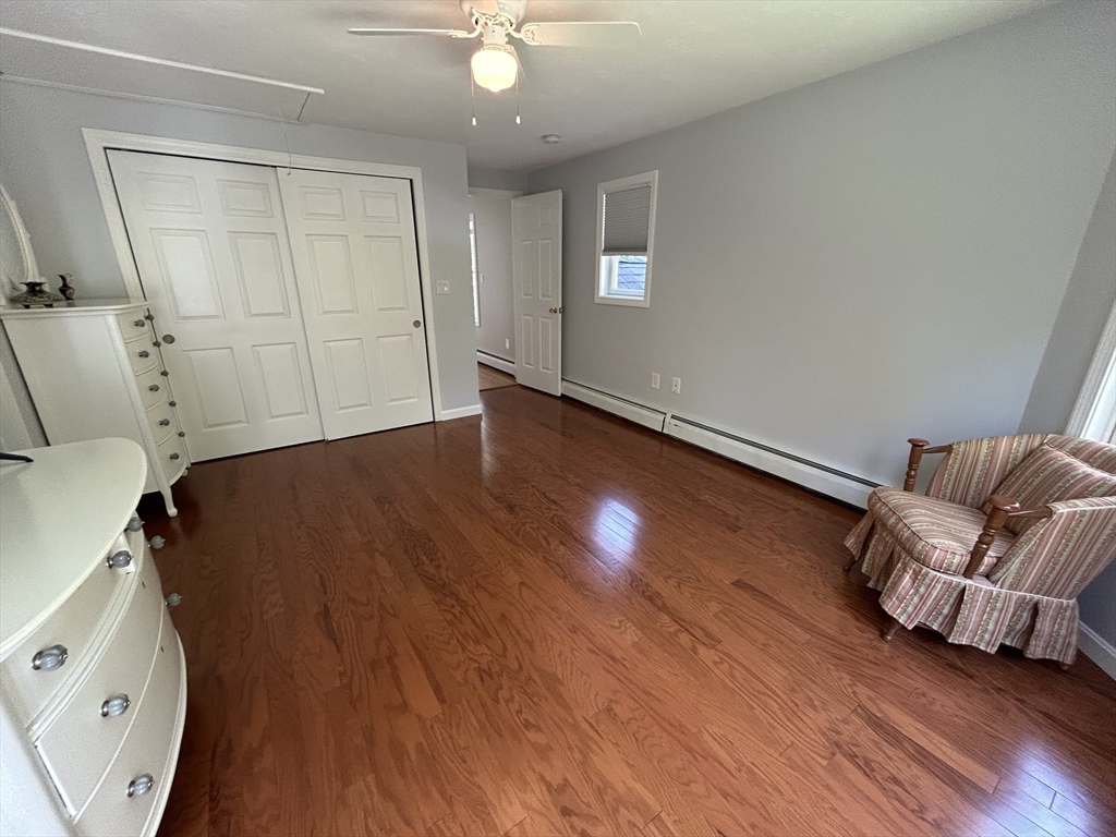 31 Bay Path Road Charlton, MA 01507 - Photo 23 of 42 an empty room with wooden floor and windows