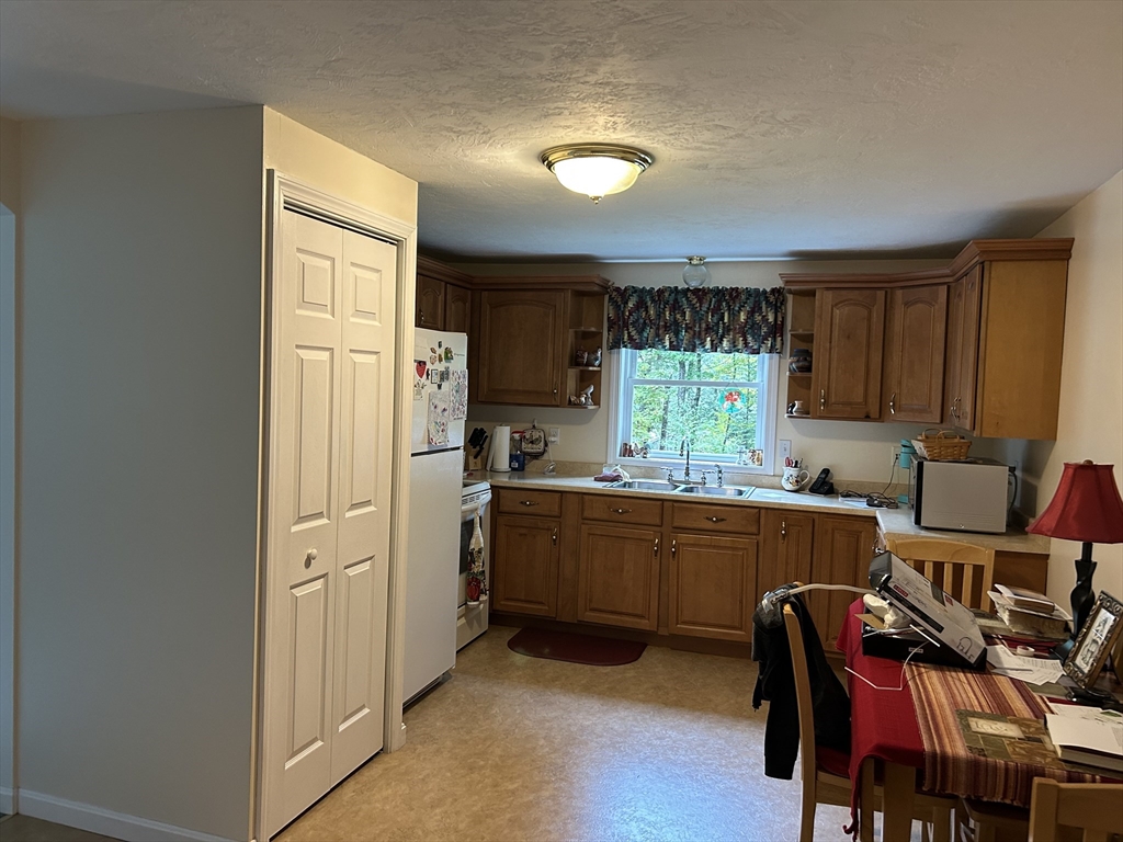 31 Bay Path Road Charlton, MA 01507 - Photo 32 of 42 a kitchen with stainless steel appliances granite countertop a refrigerator and a stove top oven