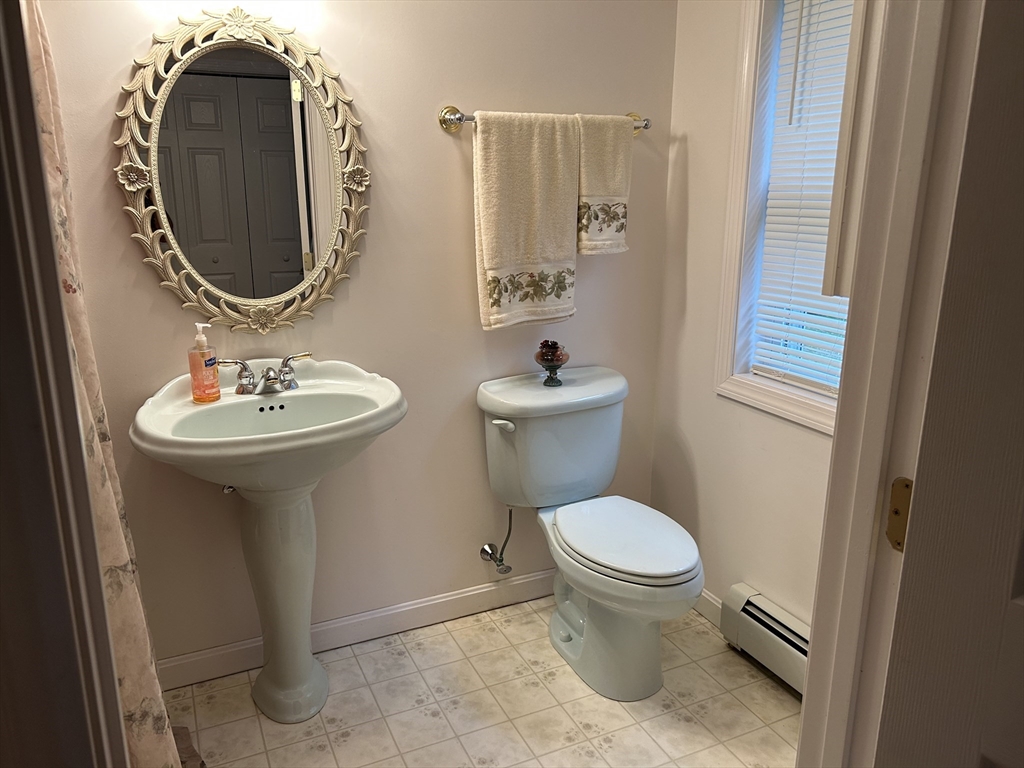 31 Bay Path Road Charlton, MA 01507 - Photo 38 of 42 a bathroom with a toilet sink and mirror