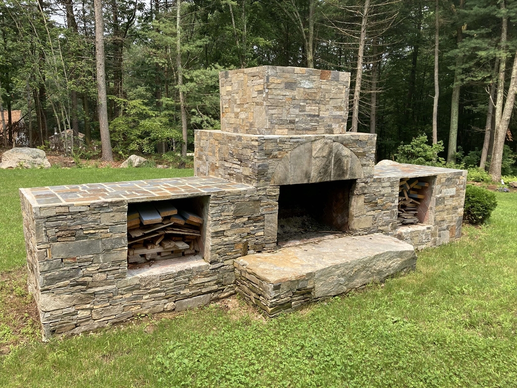 31 Bay Path Road Charlton, MA 01507 - Photo 9 of 42 a view of a fireplace with a table and chairs