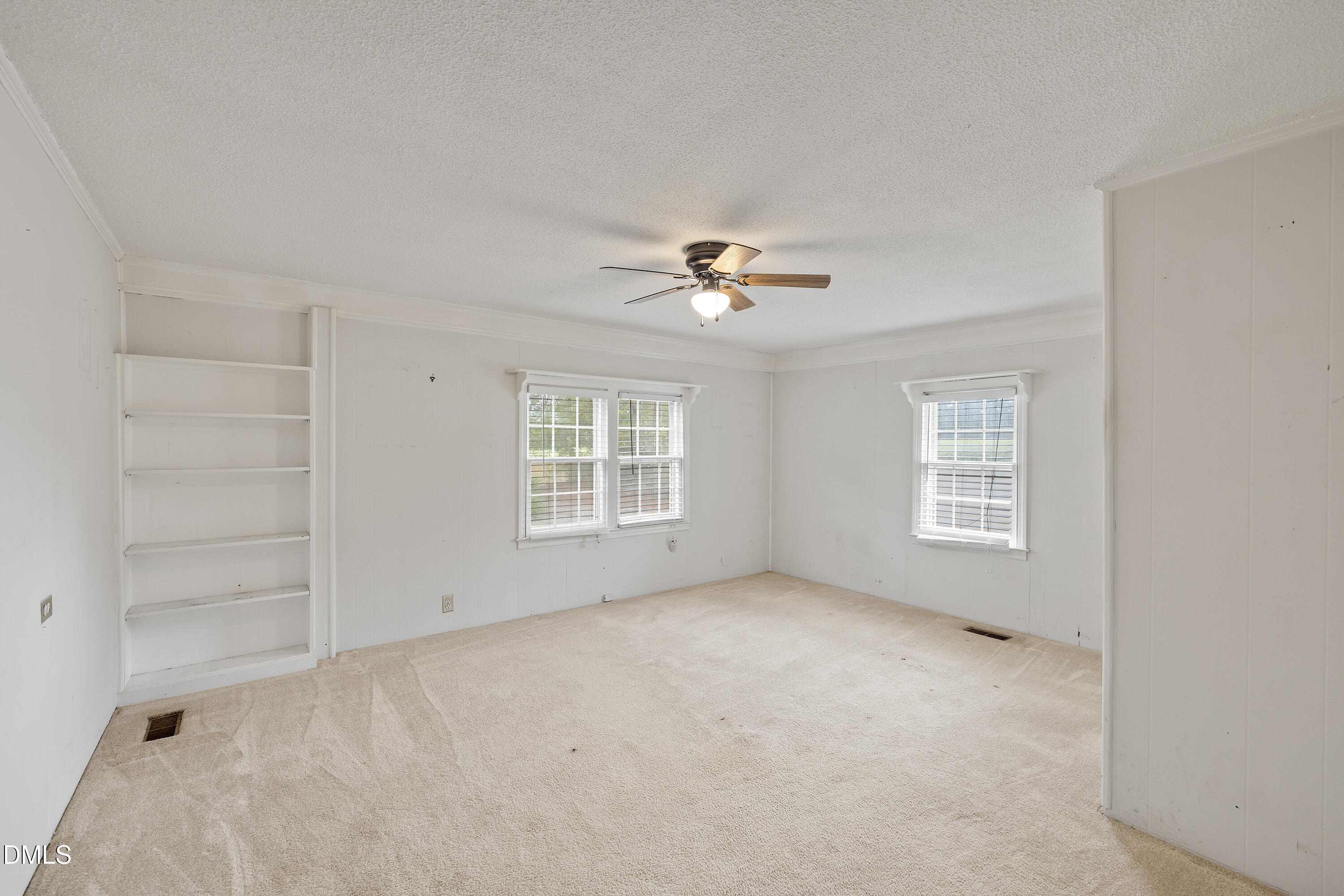 821 Penny Road Angier, NC 27501 - Photo 13 of 25 an empty room with windows and chandelier fan