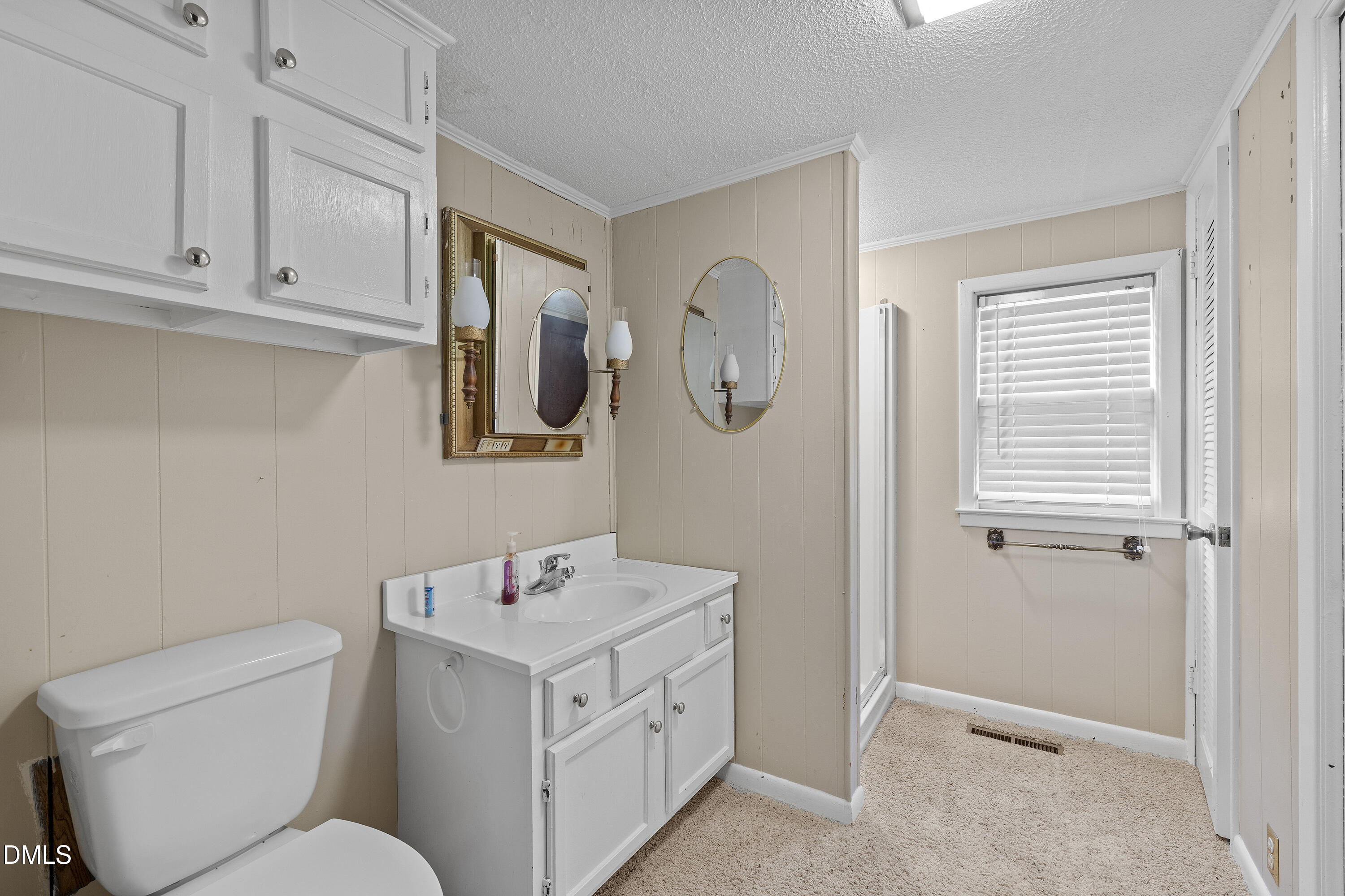 821 Penny Road Angier, NC 27501 - Photo 15 of 25 a bathroom with a toilet sink and mirror
