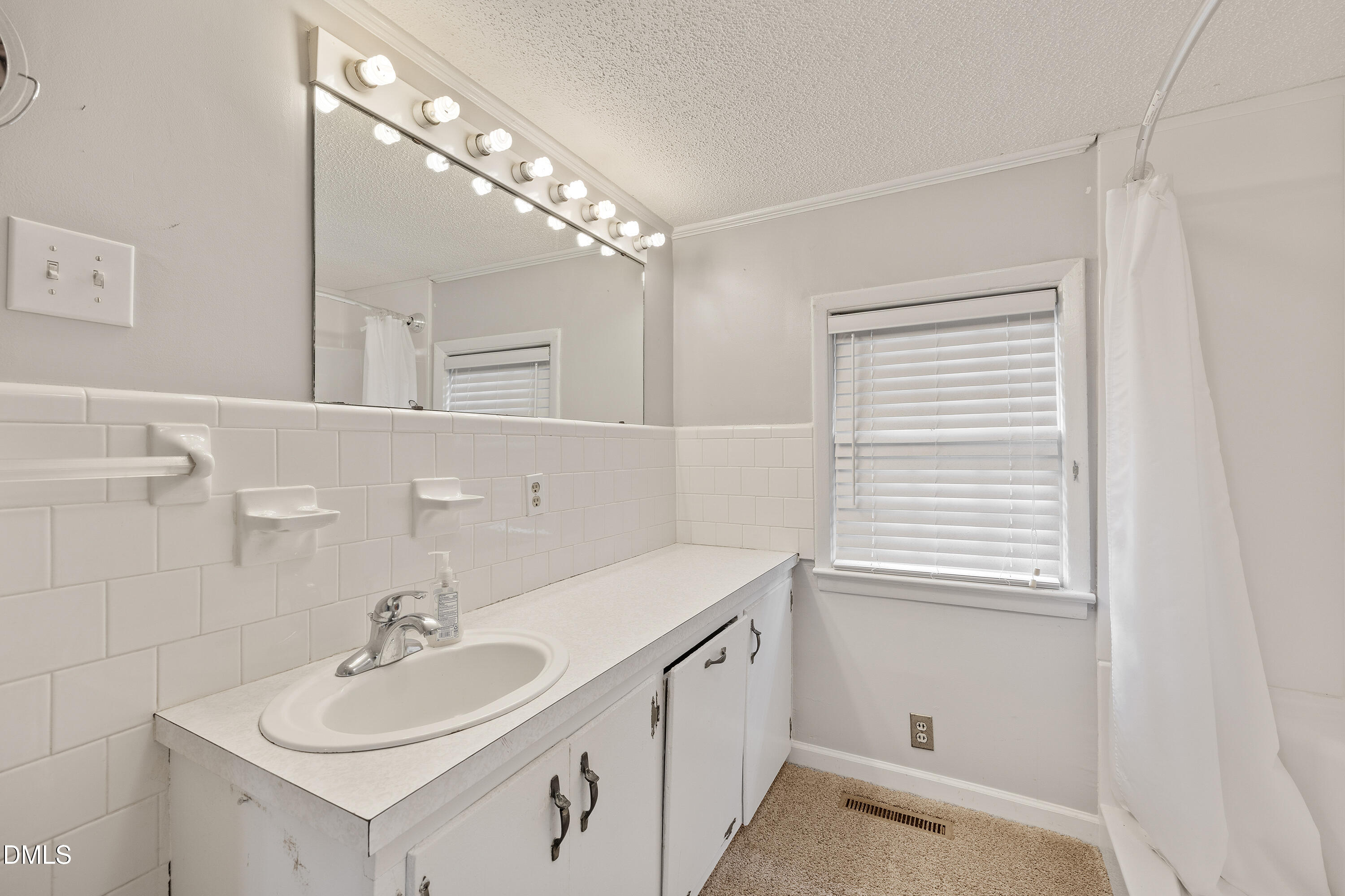 821 Penny Road Angier, NC 27501 - Photo 16 of 25 a bathroom with a sink a vanity and a mirror