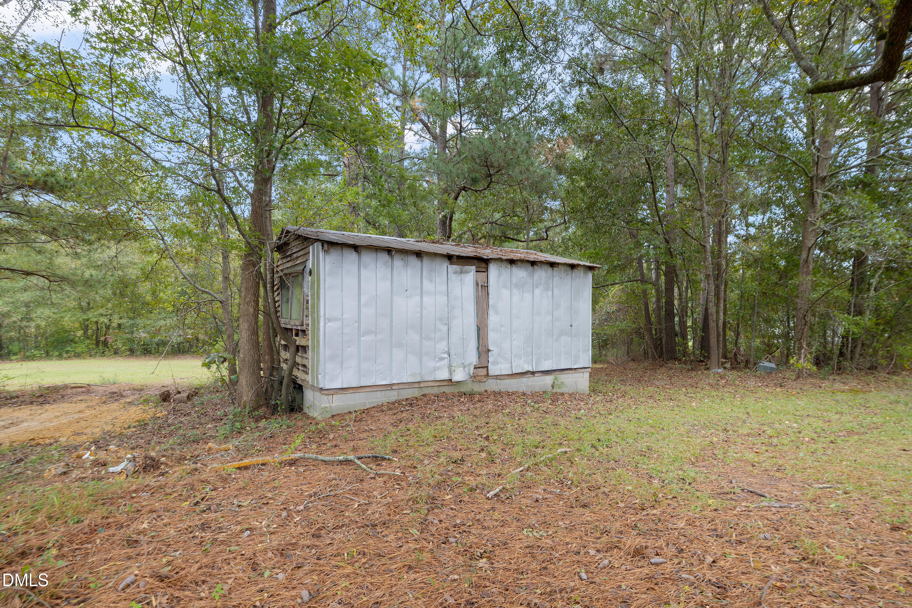 821 Penny Road Angier, NC 27501 - Photo 19 of 25 a view of backyard with large trees and wooden fence