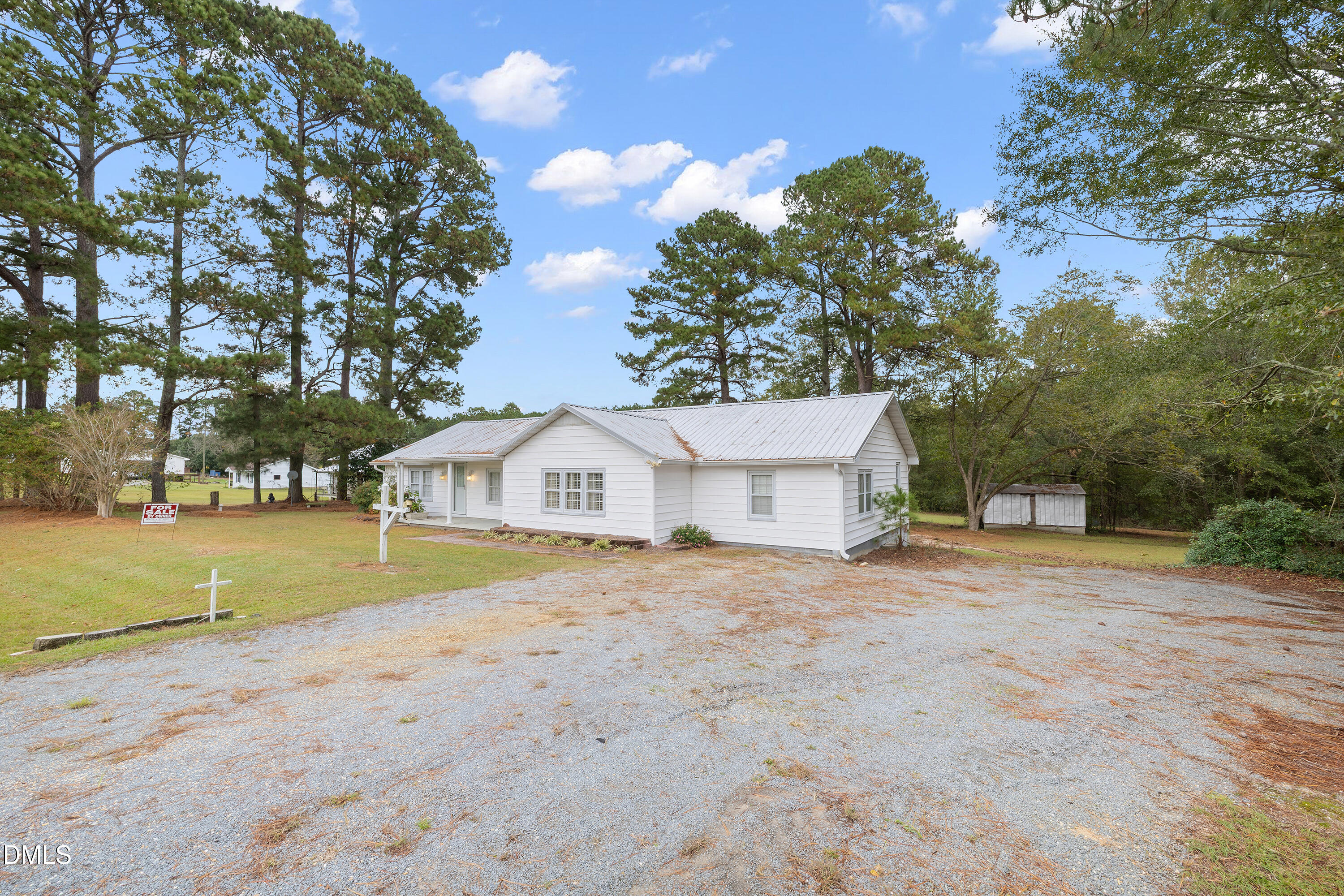 821 Penny Road Angier, NC 27501 - Photo 2 of 25 a view of a house with a yard and large trees