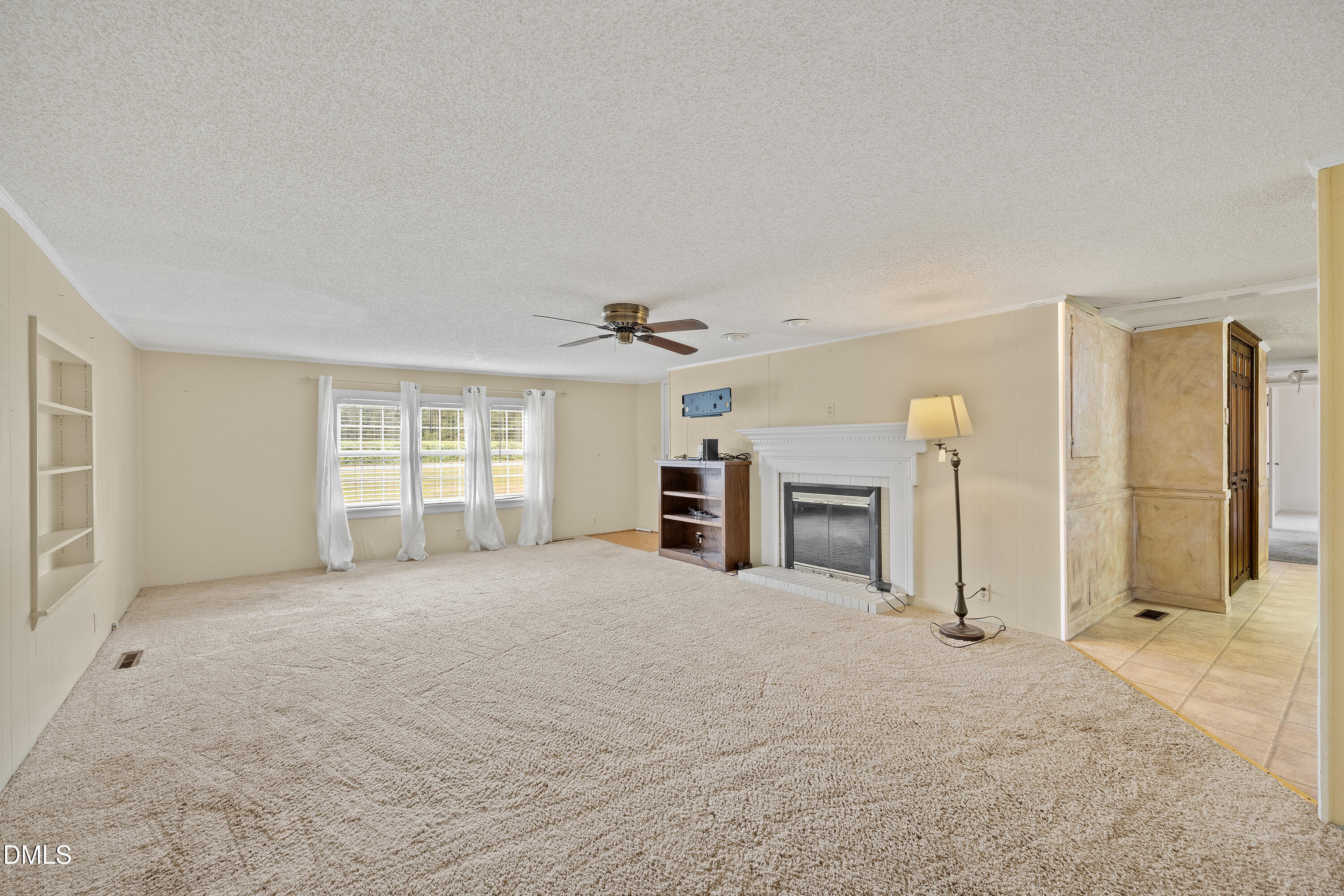 821 Penny Road Angier, NC 27501 - Photo 5 of 25 a view of a livingroom with a fireplace and window
