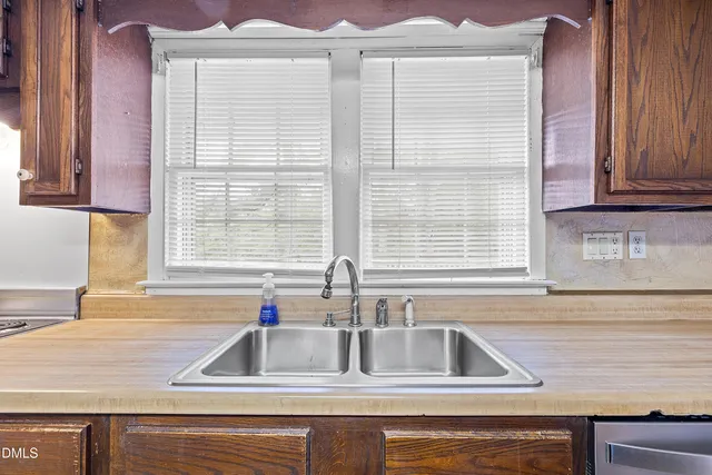a kitchen with two sink and cabinets