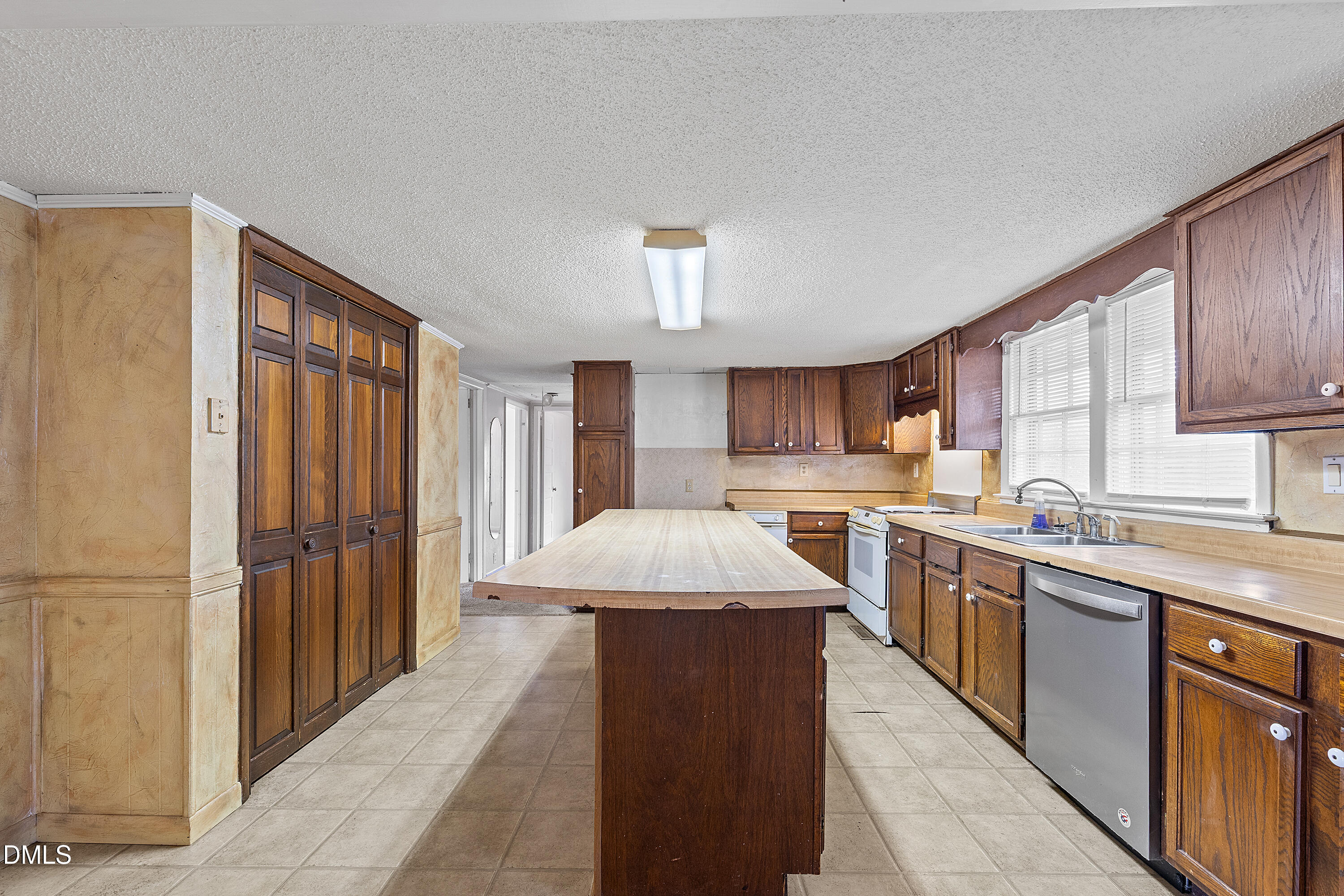 821 Penny Road Angier, NC 27501 - Photo 10 of 25 a large kitchen with stainless steel appliances kitchen island granite countertop a refrigerator a sink dishwasher a stove and a dining table with wooden cabinet