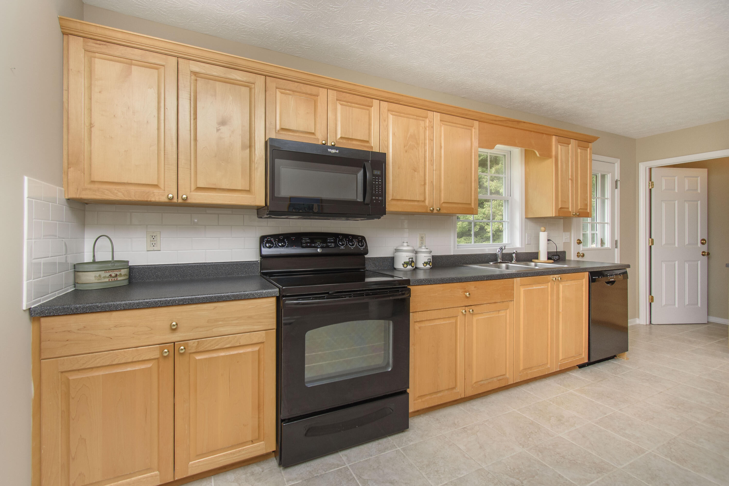 584 Kings Store Road Northeast Floyd, VA 24091 - Photo 24 of 51 a kitchen with granite countertop white cabinets sink and stainless steel appliances