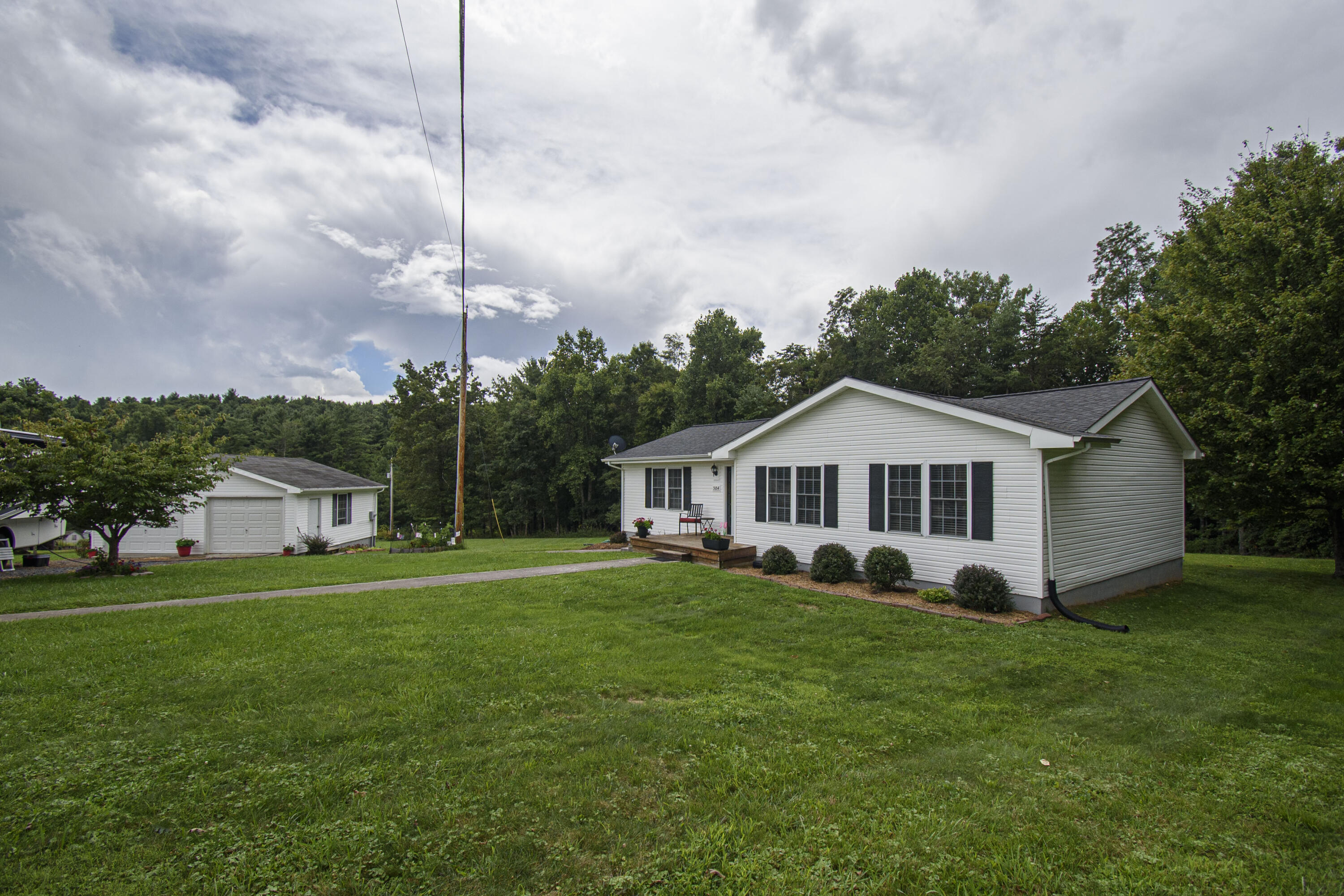 584 Kings Store Road Northeast Floyd, VA 24091 - Photo 3 of 51 a view of a house with a big yard and potted plants