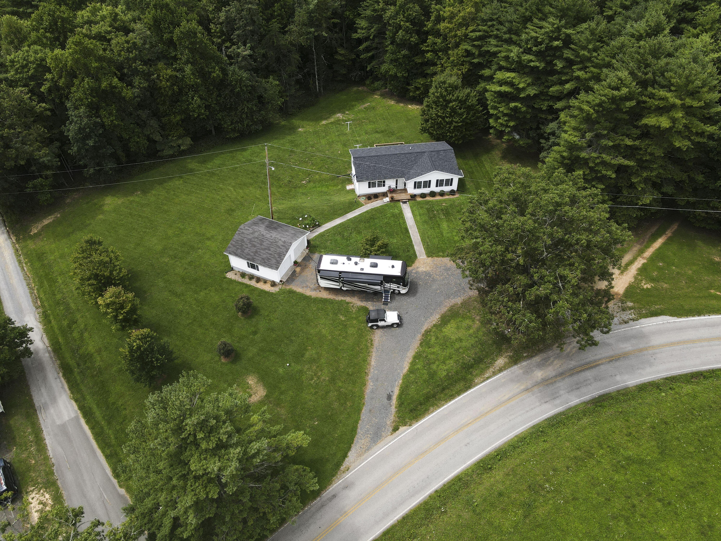 584 Kings Store Road Northeast Floyd, VA 24091 - Photo 51 of 51 an aerial view of a house with a garden and trees