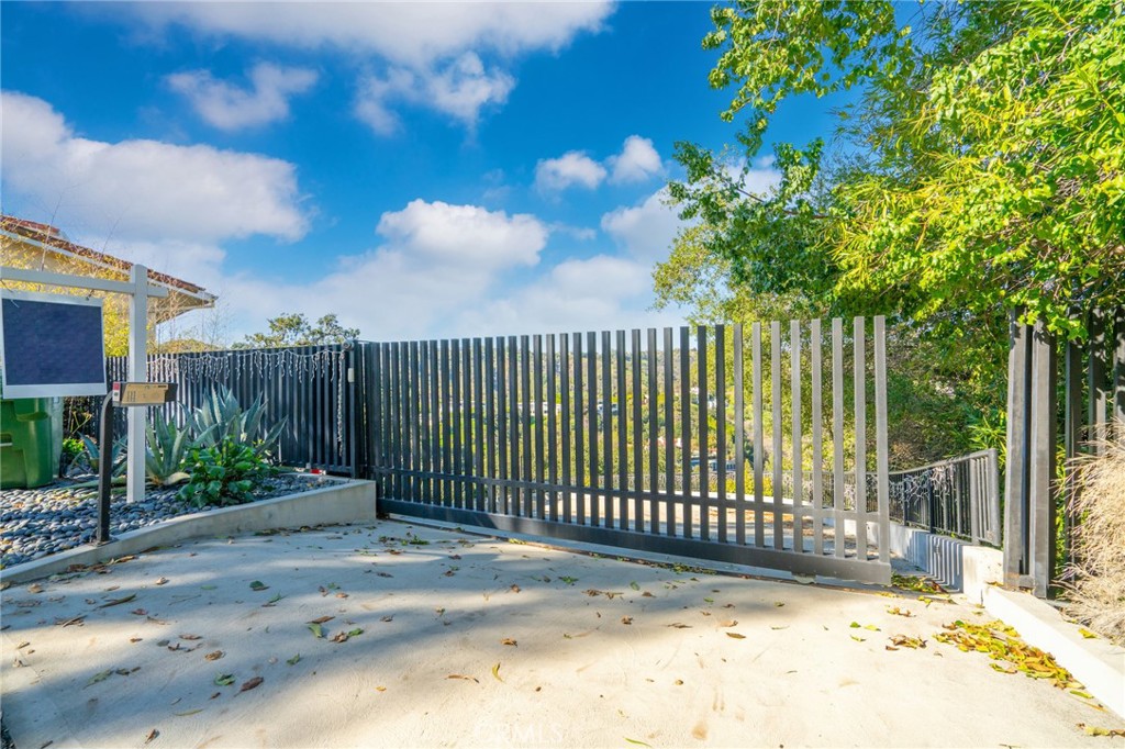 9716 Oak Pass Road Beverly Hills, CA 90210 - Photo 54 of 63 a view of a wrought iron fence