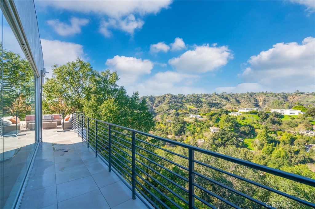 9716 Oak Pass Road Beverly Hills, CA 90210 - Photo 59 of 63 a view of a balcony with wooden floor