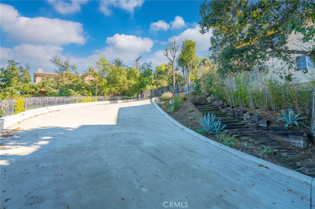 9716 Oak Pass Road Beverly Hills, CA 90210 - Photo 63 of 63 a view of a yard with plants and trees
