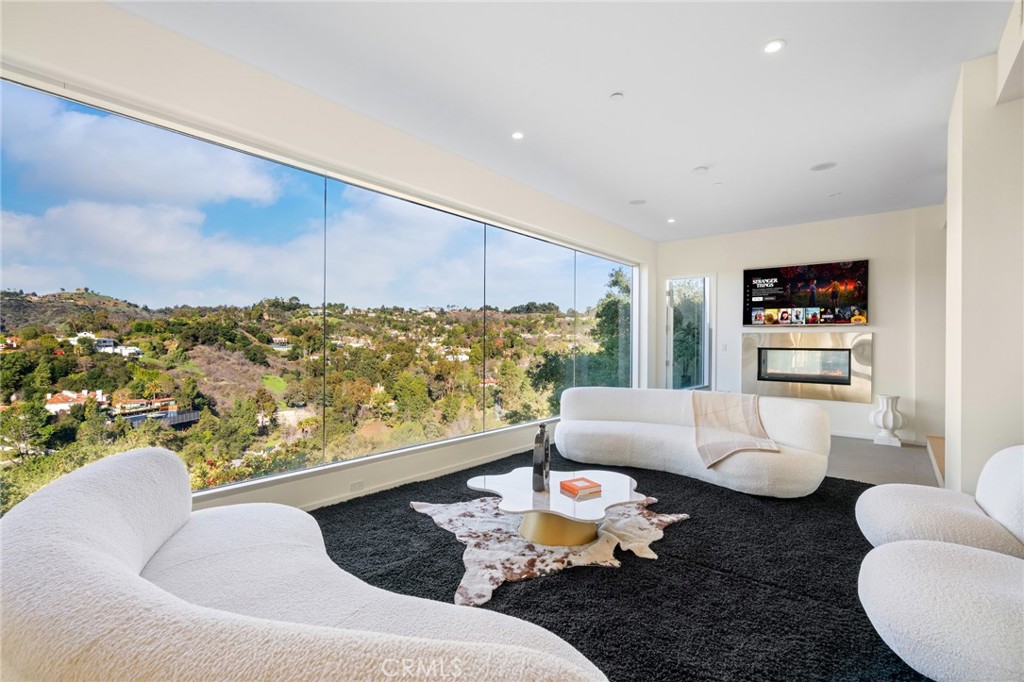 9716 Oak Pass Road Beverly Hills, CA 90210 - Photo 8 of 63 a living room with furniture and a large window