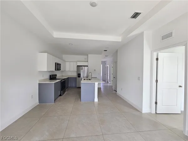 a large white kitchen with a cabinets and counter space