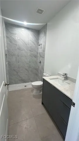a bathroom with a bathtub sink vanity and toilet
