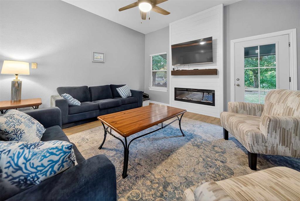 128 Armada Loop Payne Springs, TX 75156 - Photo 14 of 33 a living room with furniture a flat screen tv and a fireplace
