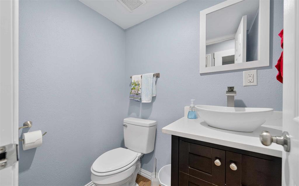 128 Armada Loop Payne Springs, TX 75156 - Photo 16 of 33 a bathroom with a toilet a sink and mirror