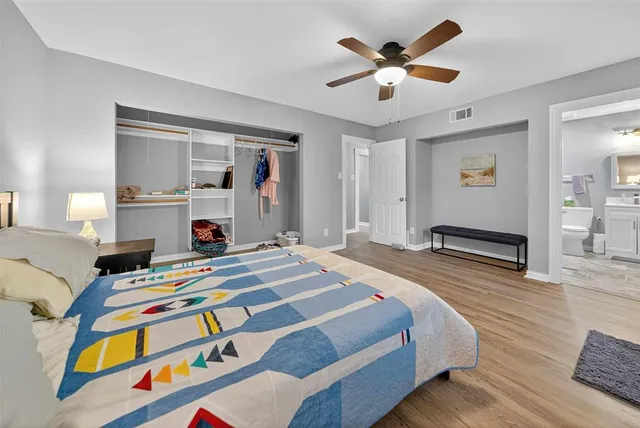 a bedroom that has a bed and a chandelier